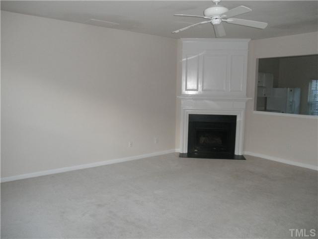 5205 Echo Ridge Road Raleigh, NC 27612 - Photo 2 of 10 an empty room with fan and fireplace