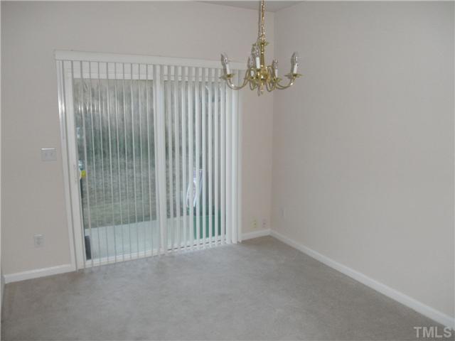 5205 Echo Ridge Road Raleigh, NC 27612 - Photo 3 of 10 an empty room with chandelier fan