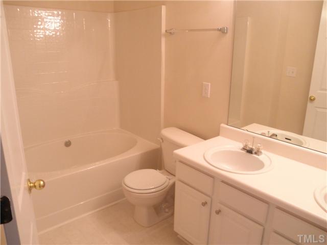 5205 Echo Ridge Road Raleigh, NC 27612 - Photo 8 of 10 a bathroom with a sink a toilet and shower