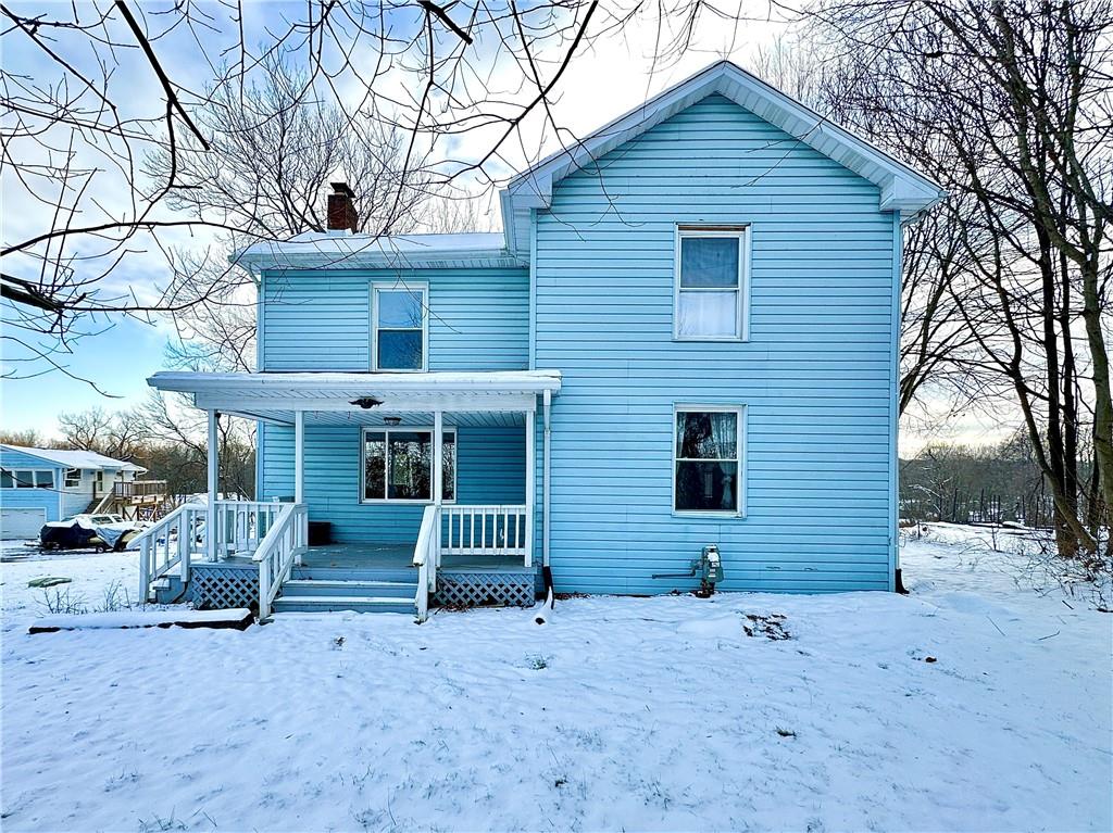 a view of a house with a yard and wooden fence