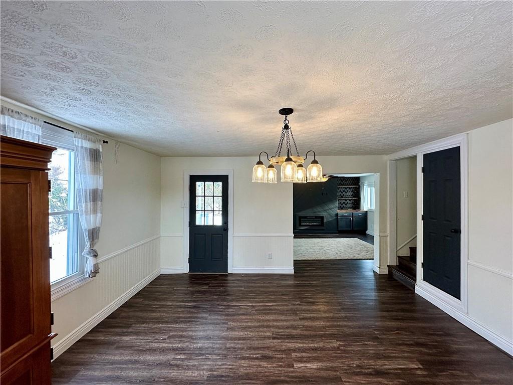 3758 Ellwood Road New Castle, PA 16101 - Photo 14 of 33 a view of a livingroom with wooden floor and kitchen view