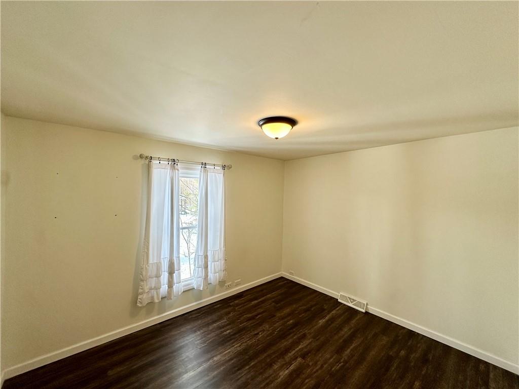 3758 Ellwood Road New Castle, PA 16101 - Photo 25 of 33 a view of an empty room with wooden floor and a window