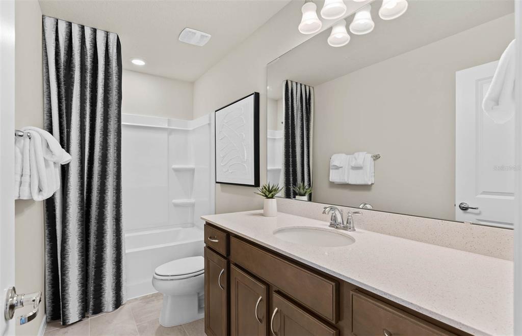 1452 Hamilton Way Lake Alfred, FL 33850 - Photo 11 of 24 a bathroom with a sink a toilet a mirror and shower