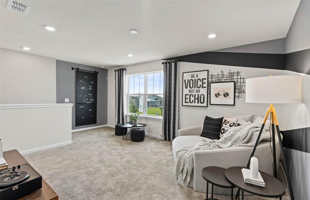 1452 Hamilton Way Lake Alfred, FL 33850 - Photo 9 of 24 a living room with furniture a large window and a flat screen tv