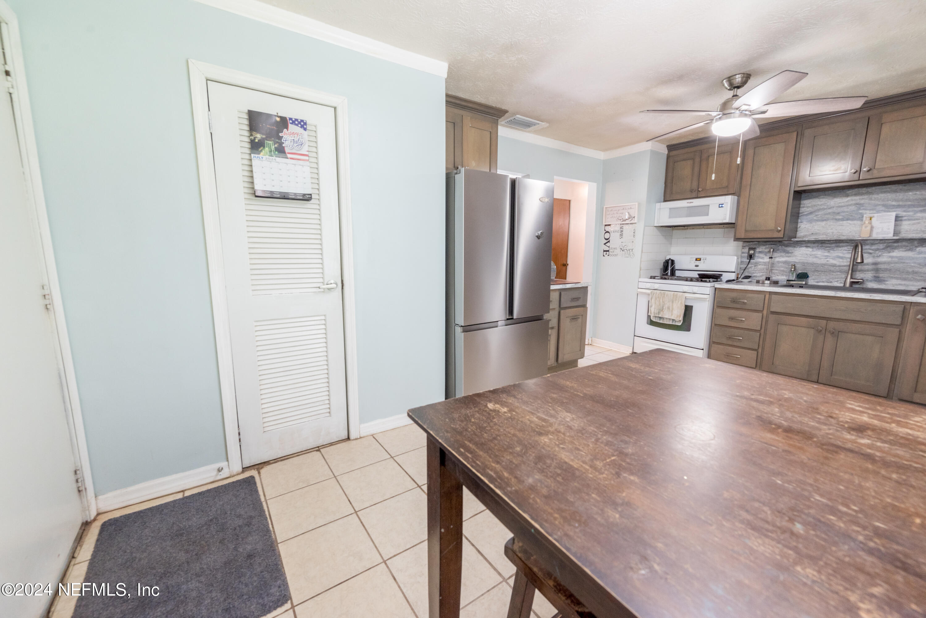 609 Collins Place Starke, FL 32091 - Photo 12 of 26 a kitchen with stainless steel appliances granite countertop a refrigerator and a stove top oven