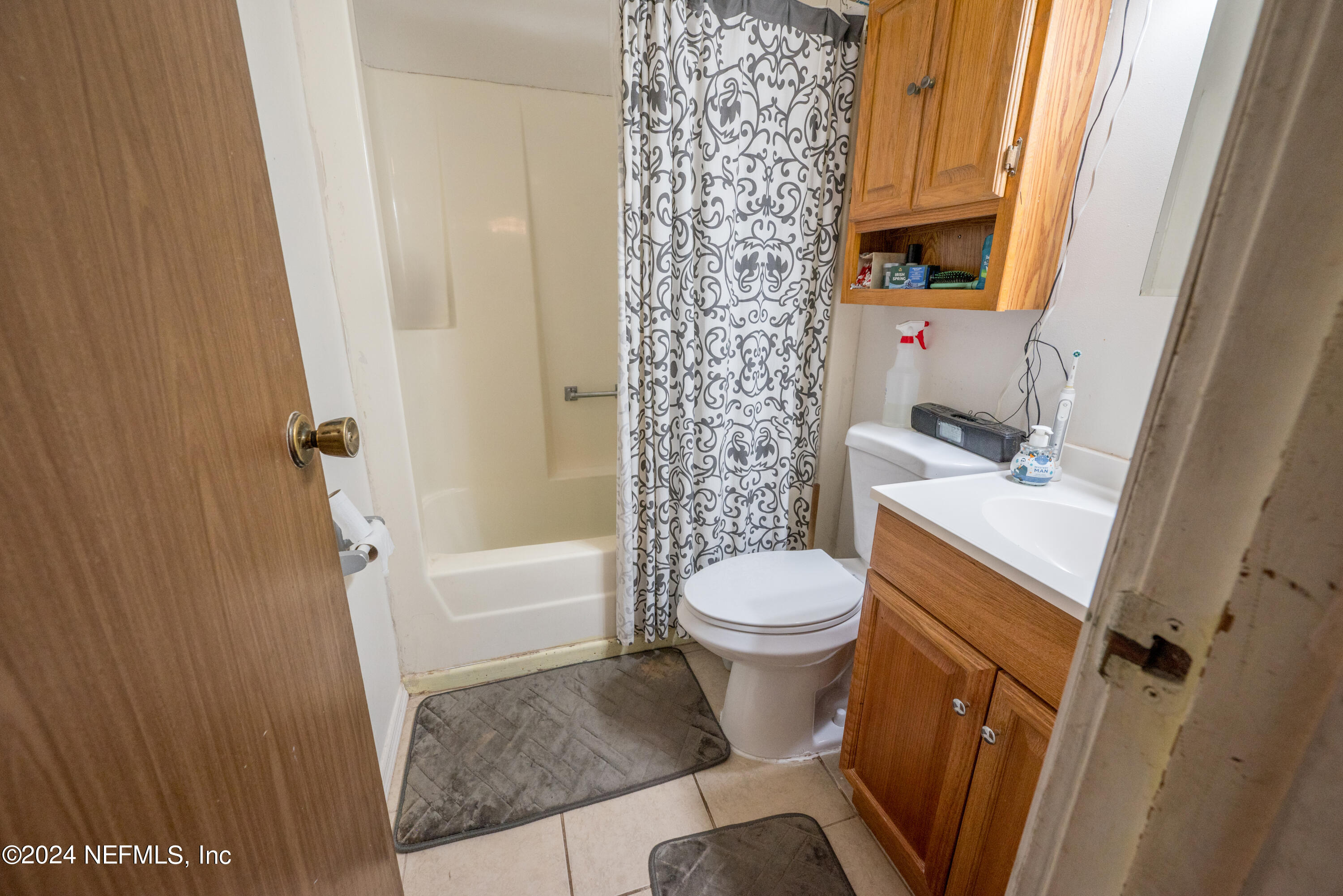609 Collins Place Starke, FL 32091 - Photo 18 of 26 a bathroom with a sink a toilet and shower