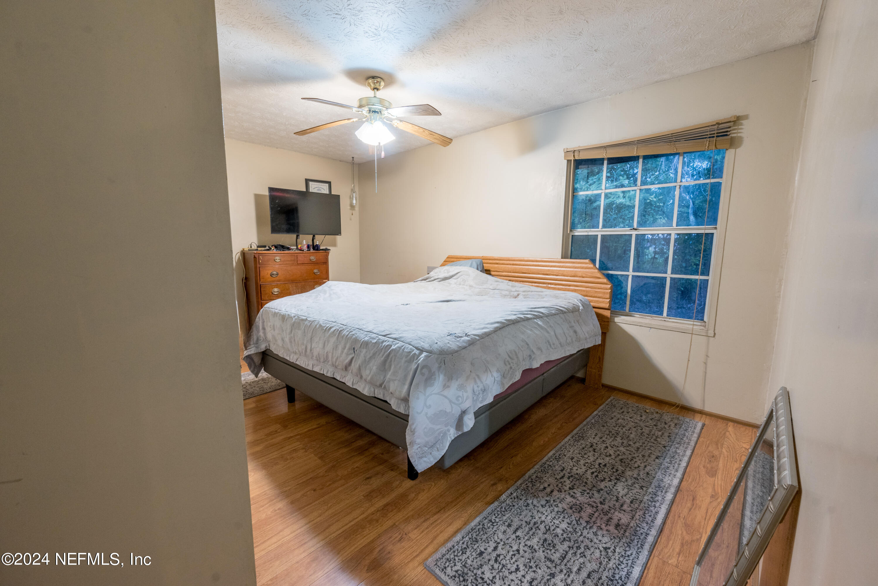 609 Collins Place Starke, FL 32091 - Photo 20 of 26 a bed sitting in a spacious bedroom next to a window
