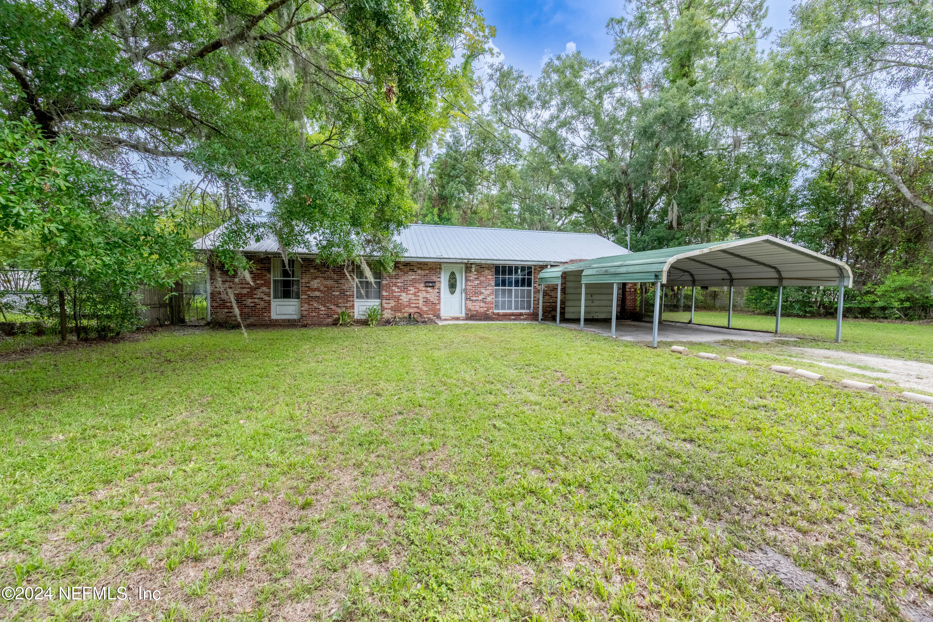 609 Collins Place Starke, FL 32091 - Photo 2 of 26 a view of a house with a yard porch and sitting area
