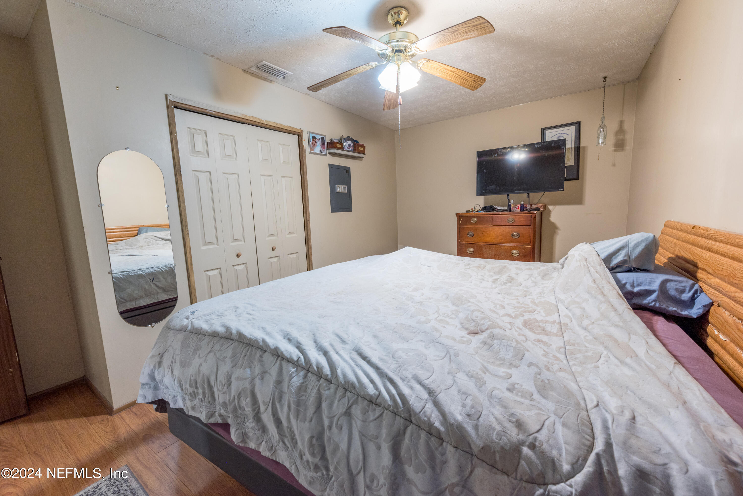 609 Collins Place Starke, FL 32091 - Photo 21 of 26 a bedroom with a bed and a flat screen tv