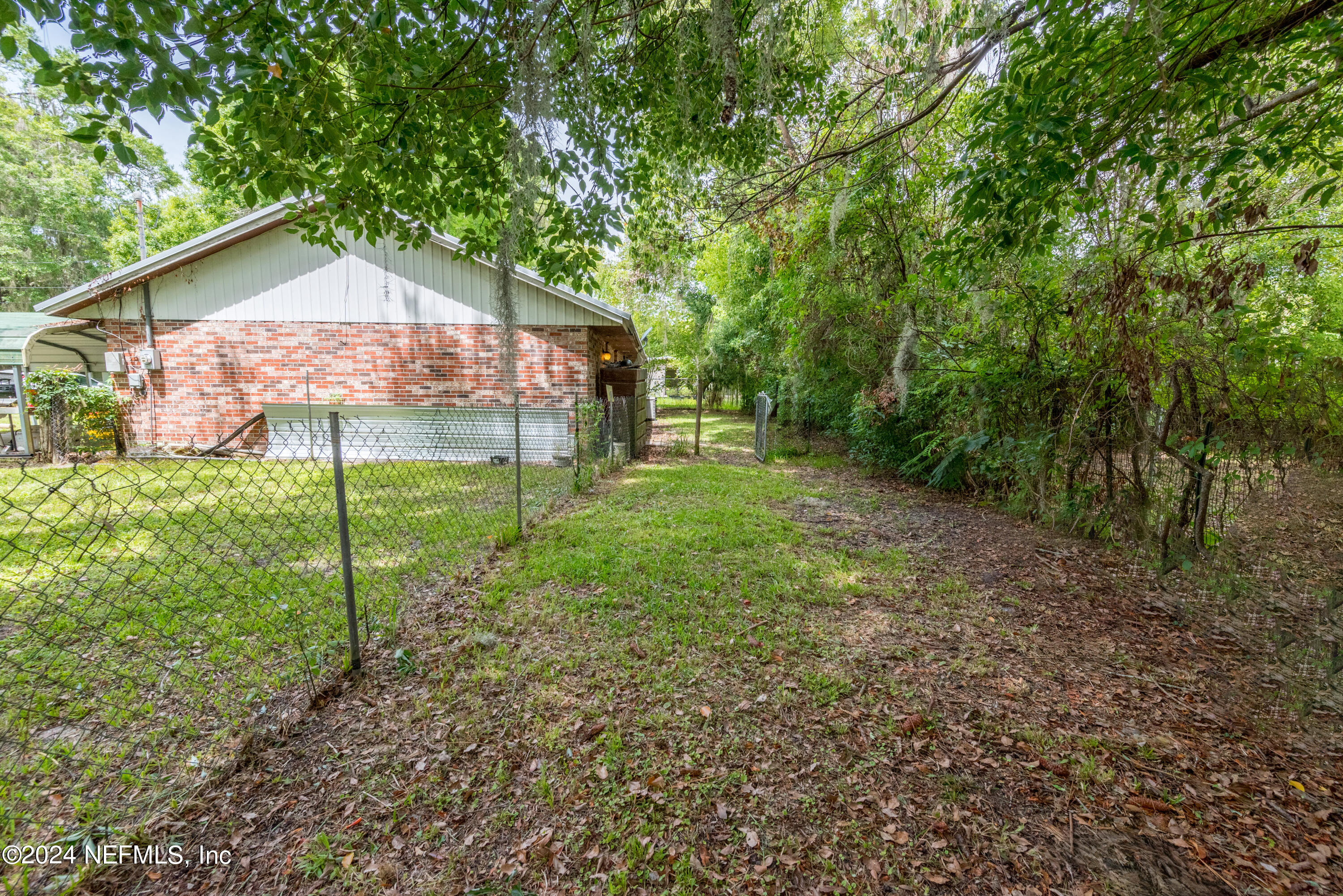 609 Collins Place Starke, FL 32091 - Photo 26 of 26 a backyard of a house with table and chairs