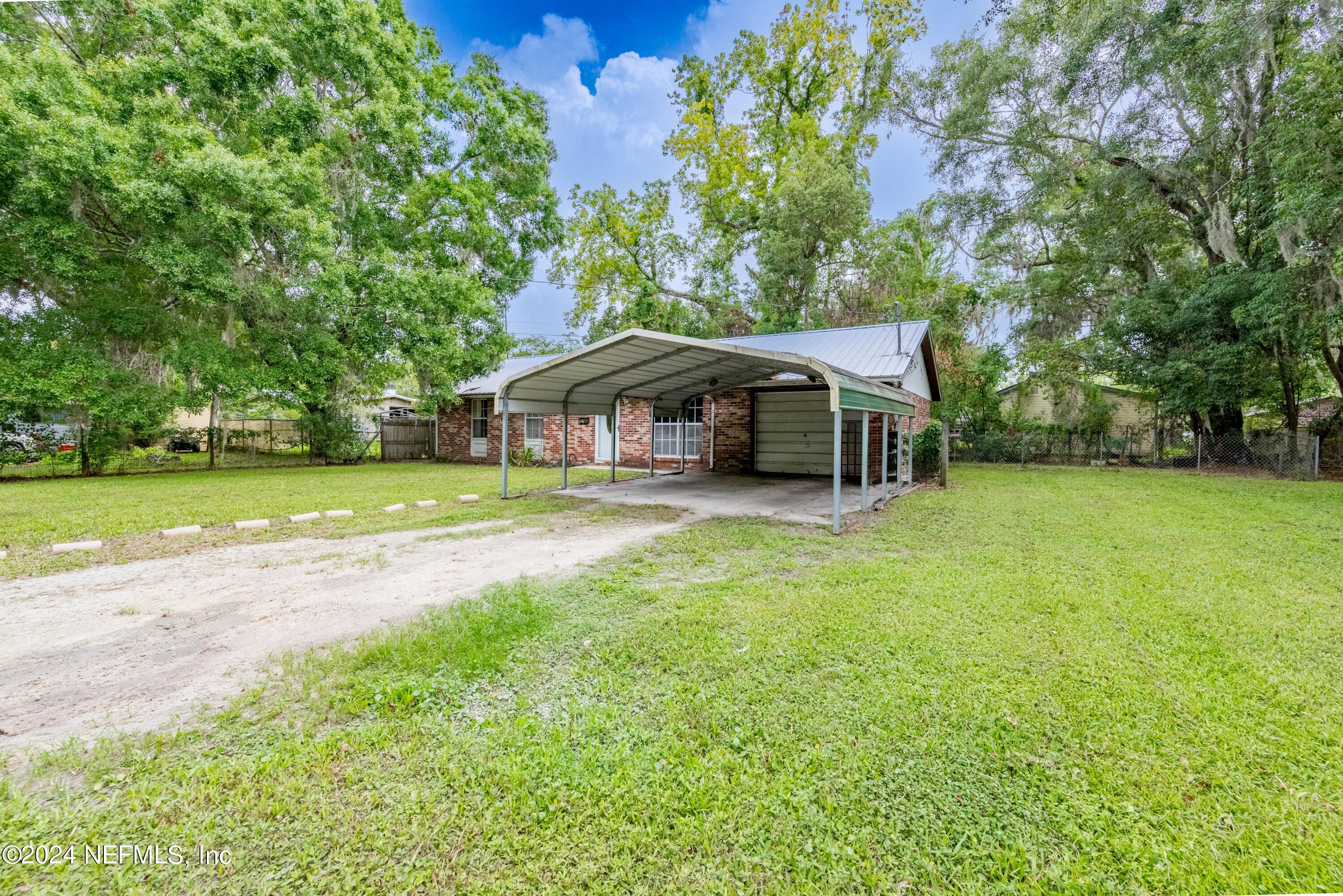 609 Collins Place Starke, FL 32091 - Photo 3 of 26 a front view of a house with yard and green space