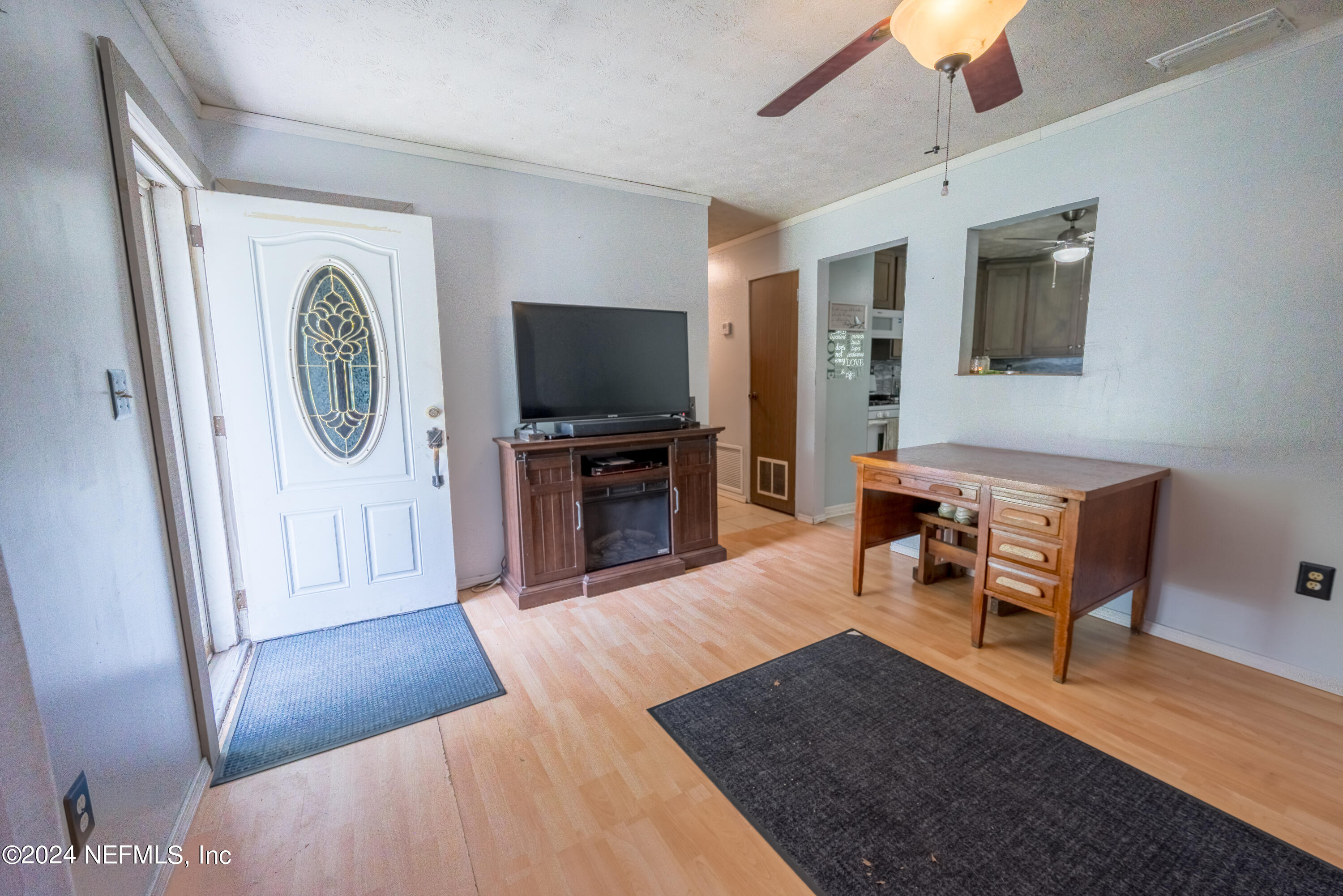 609 Collins Place Starke, FL 32091 - Photo 5 of 26 a living room with furniture and a flat screen tv
