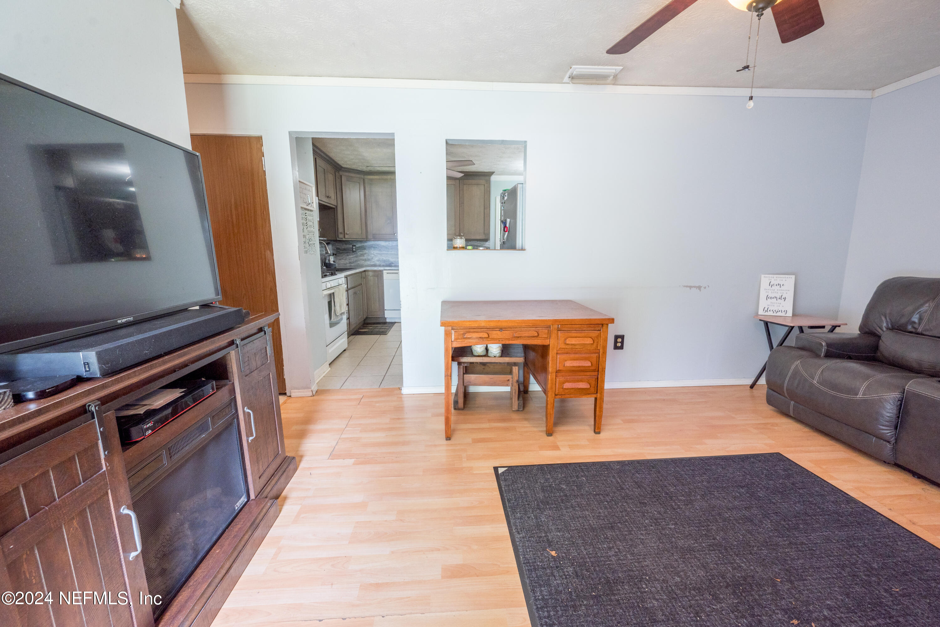 609 Collins Place Starke, FL 32091 - Photo 6 of 26 a living room with furniture and wooden floor