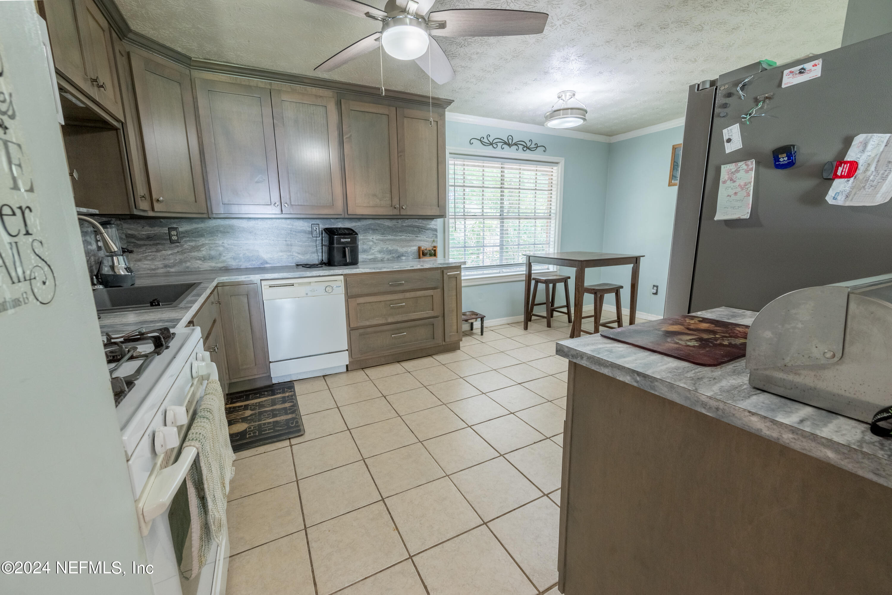 609 Collins Place Starke, FL 32091 - Photo 8 of 26 a kitchen with stainless steel appliances granite countertop a sink stove and cabinets