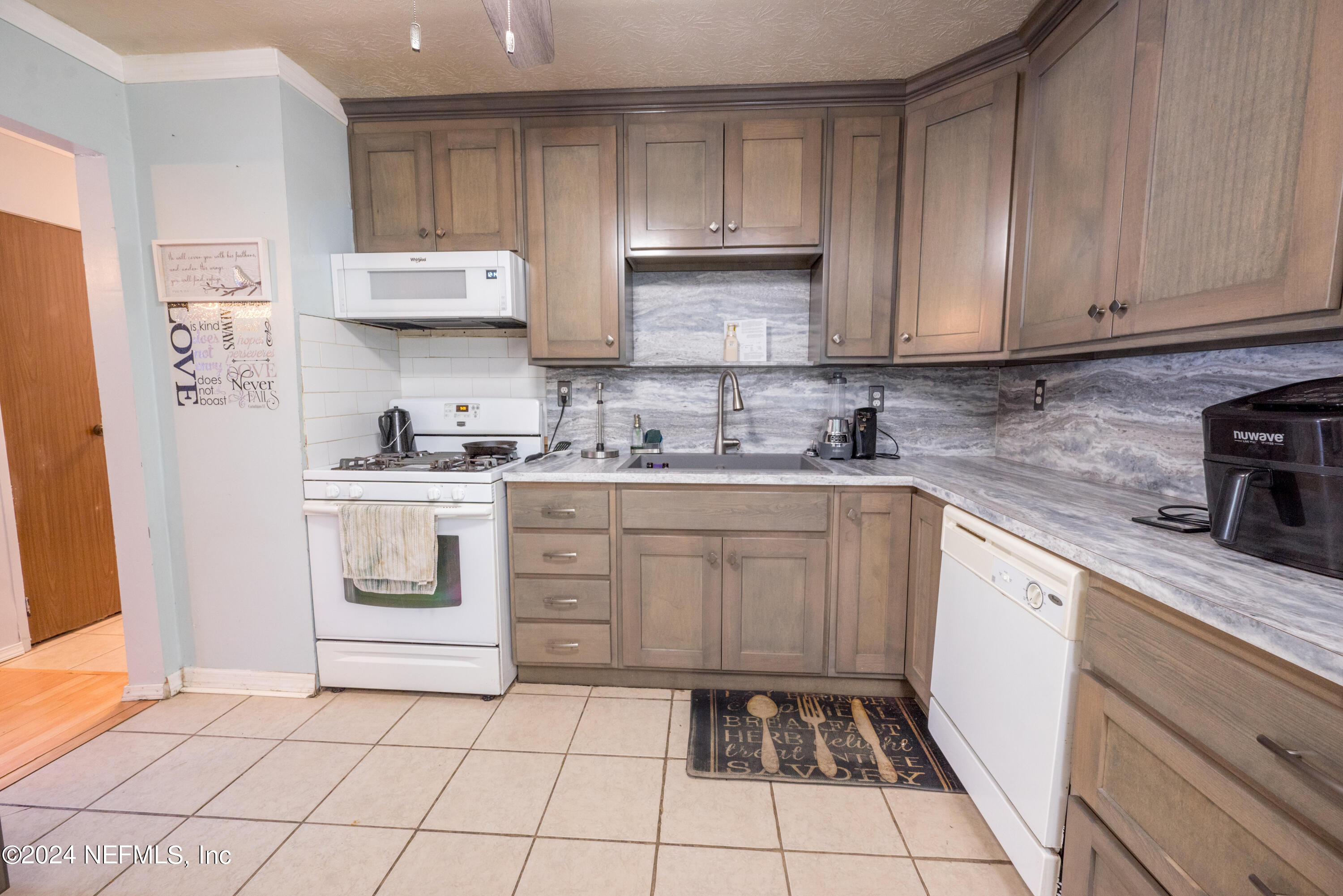 609 Collins Place Starke, FL 32091 - Photo 9 of 26 a kitchen with a sink a stove and cabinets