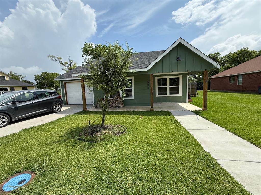 505 Thomas Street Terrell, TX 75160 - Photo 2 of 38 Green exterior siding with a covered front porch featuring wood support beams and a dark metal light fixture