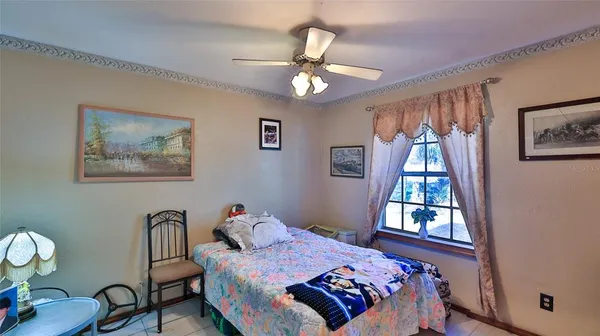 a bedroom with furniture and a window