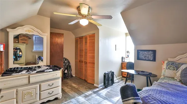 a bedroom with furniture a bed and a flat screen tv