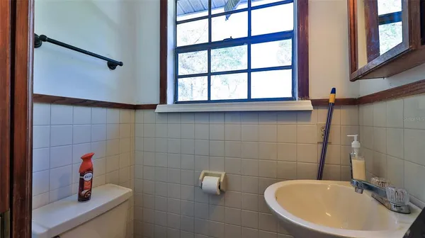 a utility room with dryer washer and shoe rack