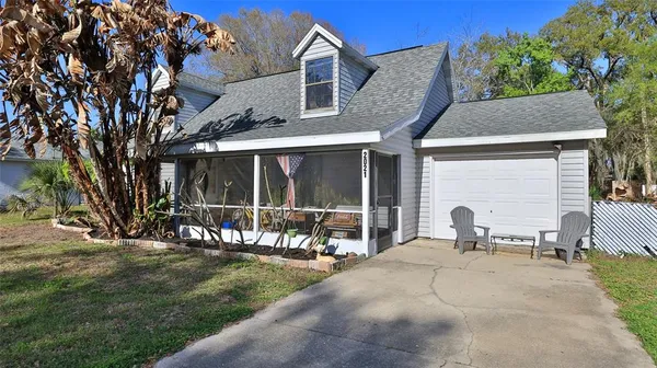 a view of a house with backyard porch and sitting area