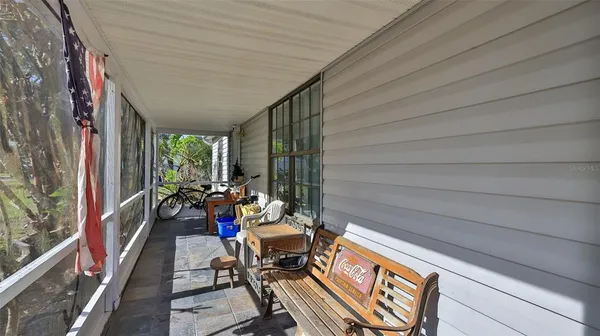 a bedroom with a bed dresser and a chandelier