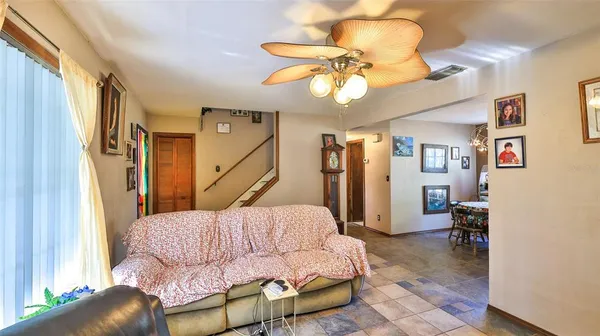 a living room with furniture and flowers
