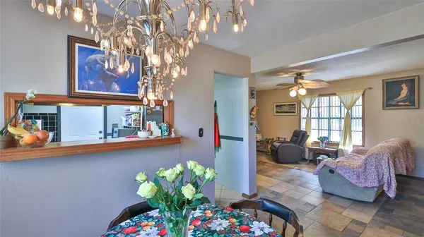 a kitchen with granite countertop lots of clutter and stainless steel appliances