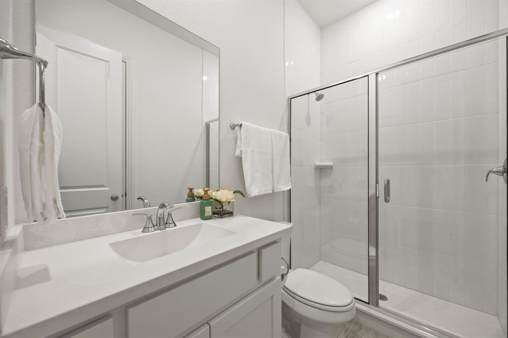 1807 Gateway Lane Van Alstyne, TX 75495 - Photo 22 of 33 a bathroom with a sink toilet and shower