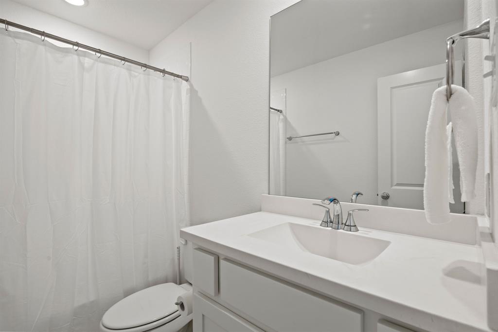 1807 Gateway Lane Van Alstyne, TX 75495 - Photo 26 of 33 a bathroom with a sink toilet and shower