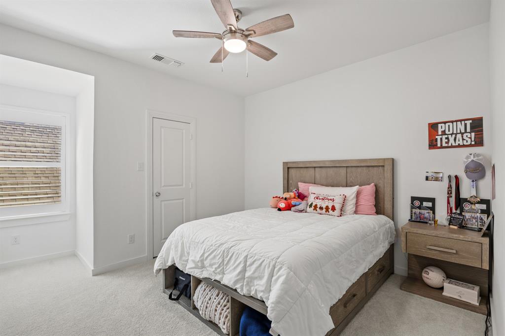 1807 Gateway Lane Van Alstyne, TX 75495 - Photo 27 of 33 a bedroom with a bed and a chandelier