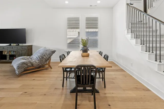 a kitchen with stainless steel appliances granite countertop a white cabinets and wooden floor