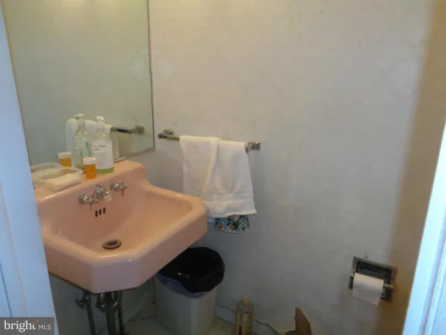 a bed room with a bed a couch and a potted plant