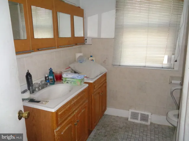 a bathroom with a sink mirror and toilet