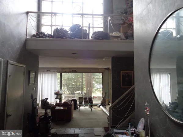 a living room with furniture and large windows