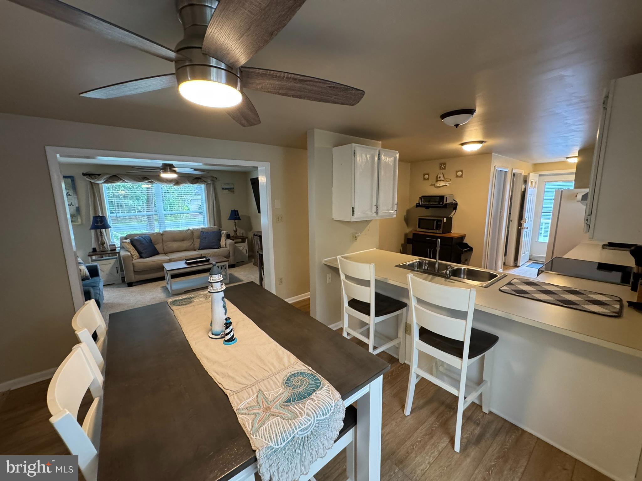 85 Pinehurst Road Ocean Pines, MD 21811 - Photo 3 of 30 a living room with furniture a chandelier and a flat screen tv
