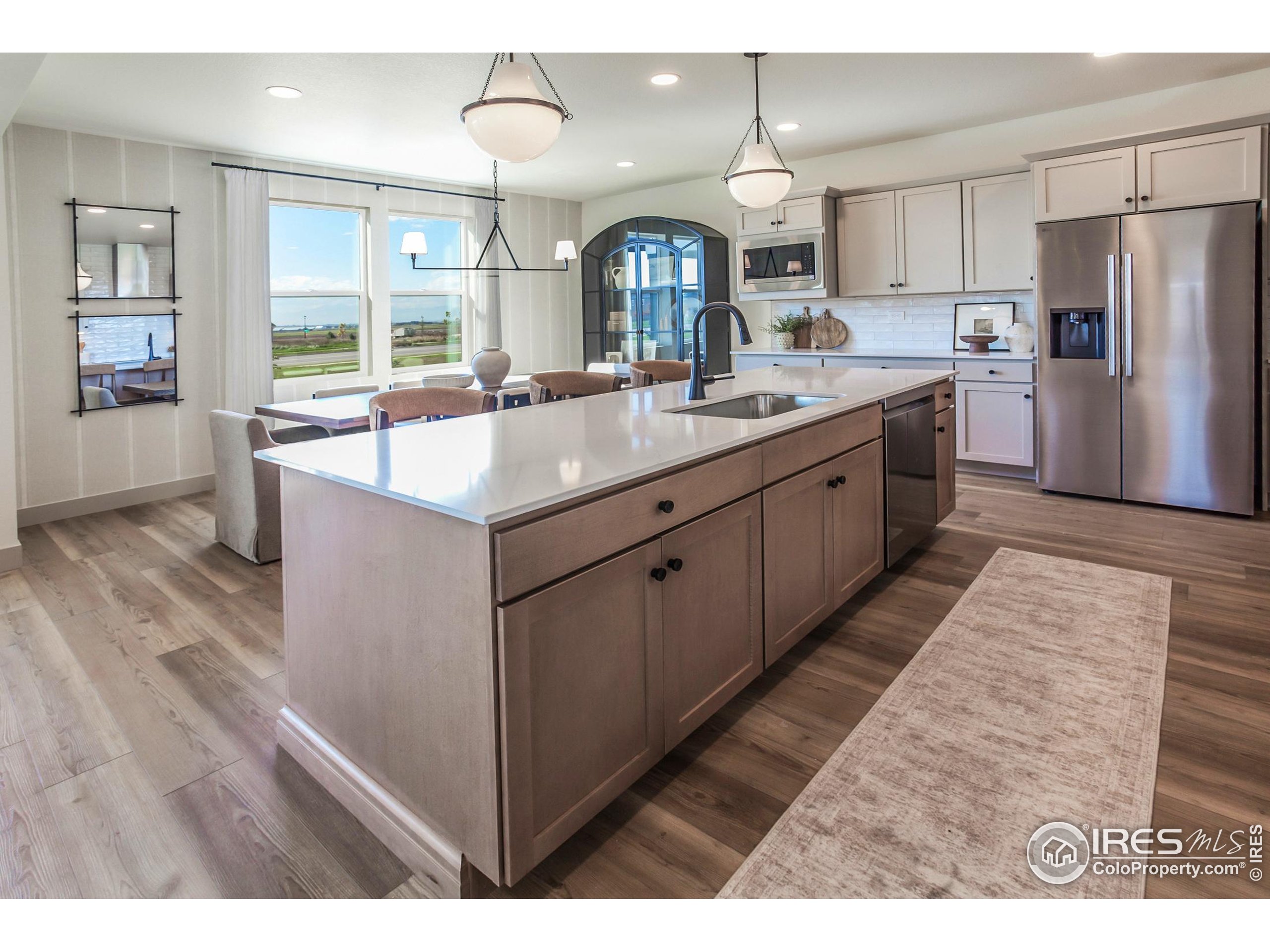 6079 Red Barn Road Fort Collins, CO 80528 - Photo 13 of 41 a large kitchen with kitchen island a sink stainless steel appliances and cabinets