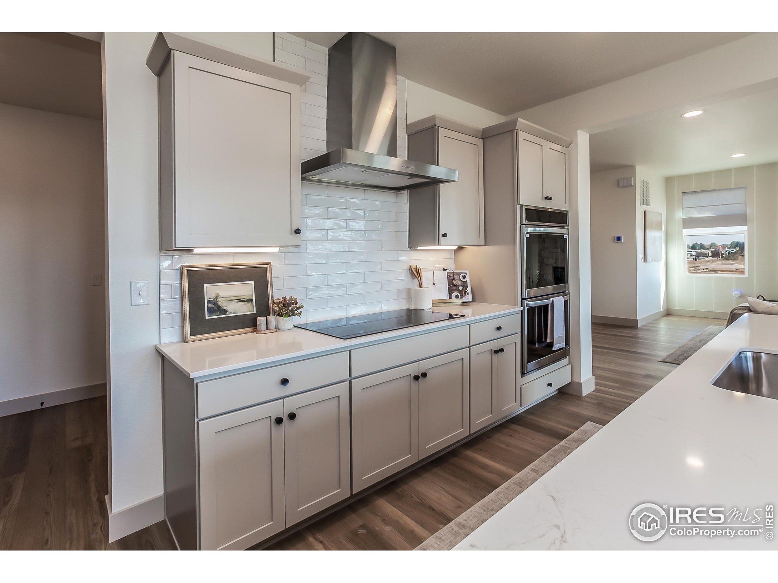 6079 Red Barn Road Fort Collins, CO 80528 - Photo 14 of 41 a kitchen with cabinets and wooden floor
