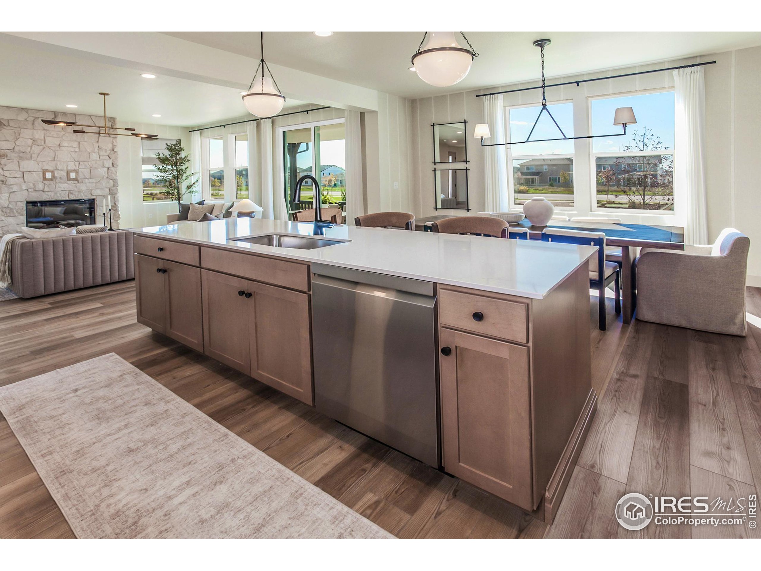 6079 Red Barn Road Fort Collins, CO 80528 - Photo 16 of 41 a kitchen with stainless steel appliances granite countertop a sink stove and wooden floor