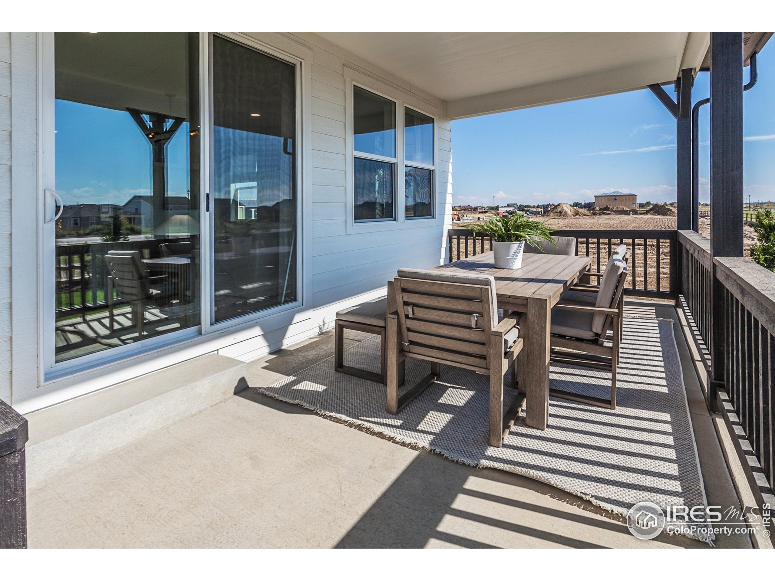 6079 Red Barn Road Fort Collins, CO 80528 - Photo 40 of 41 a dining room with furniture and a floor to ceiling window