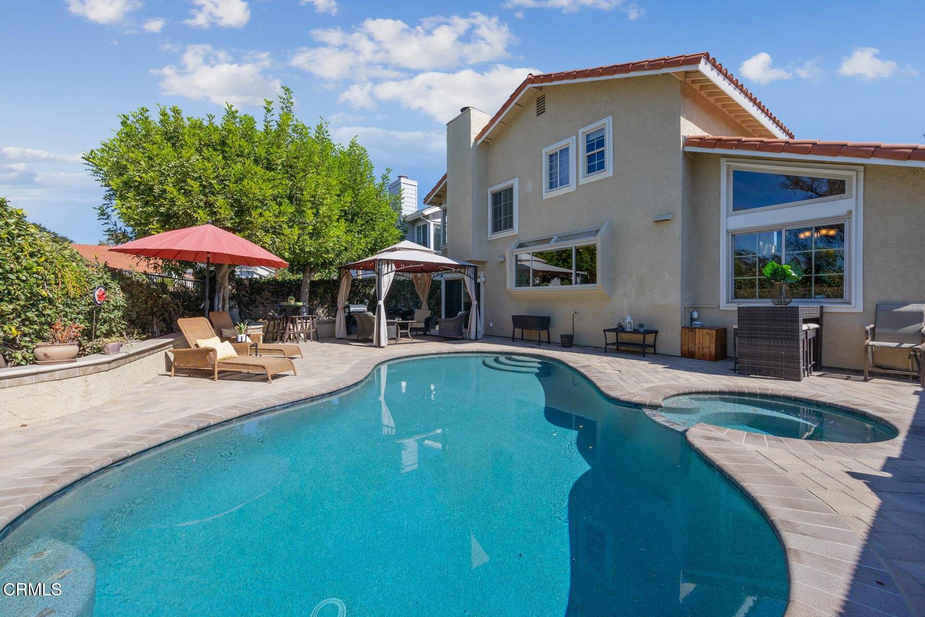 a view of a house with swimming pool and sitting area