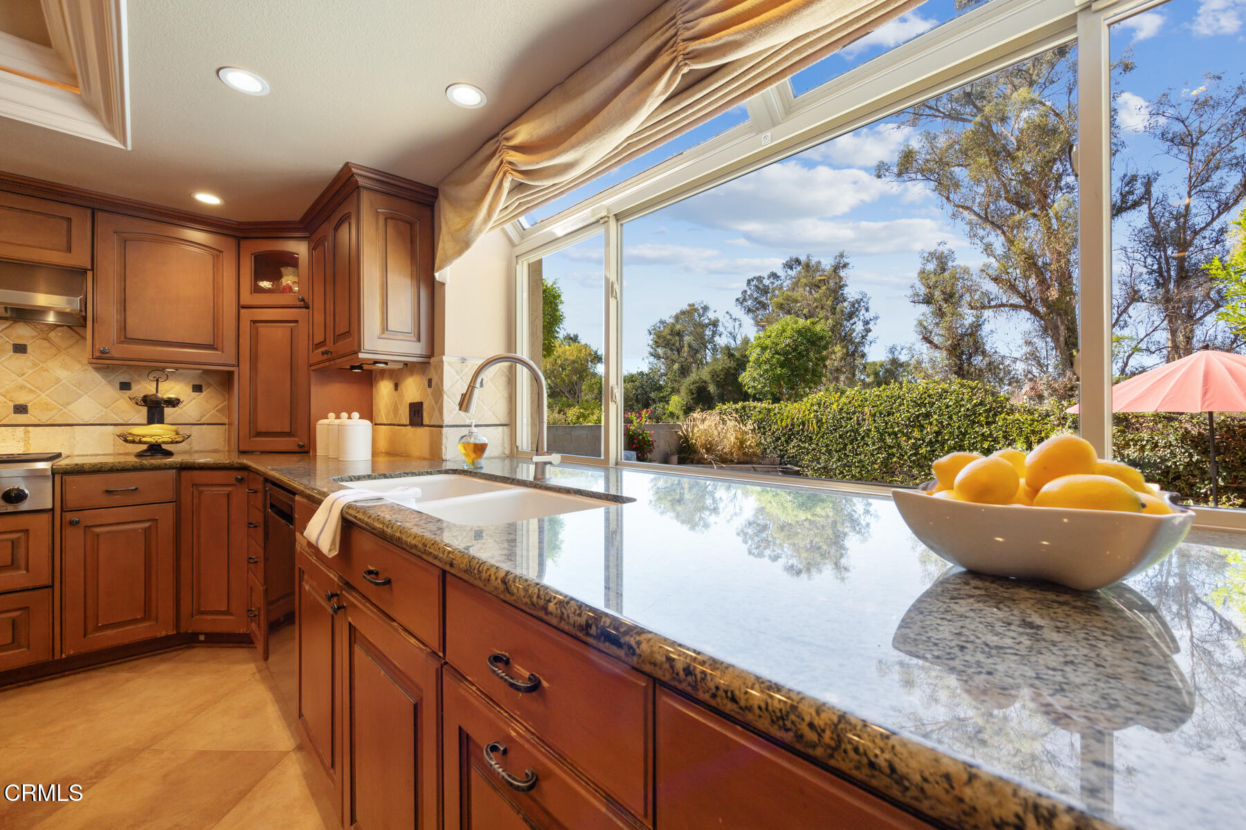 22671 Cheryl Way Lake Forest, CA 92630 - Photo 14 of 51 a large kitchen with kitchen island granite countertop a sink and a large window