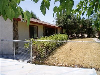 11691 Mohawk Road Apple Valley, CA 92308 - Photo 1 of 1 a front view of a house with a yard and garage