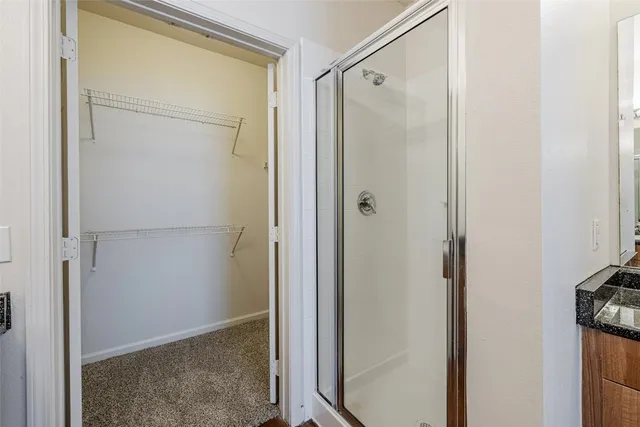 a bathroom with a sink double vanity granite and a mirror