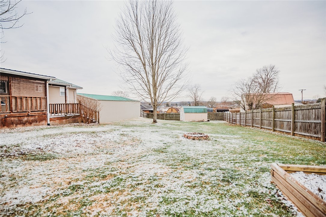 91 Mike Street Washington, WV 26181 - Photo 36 of 42 Fenced backyard with a storage unit and a deck