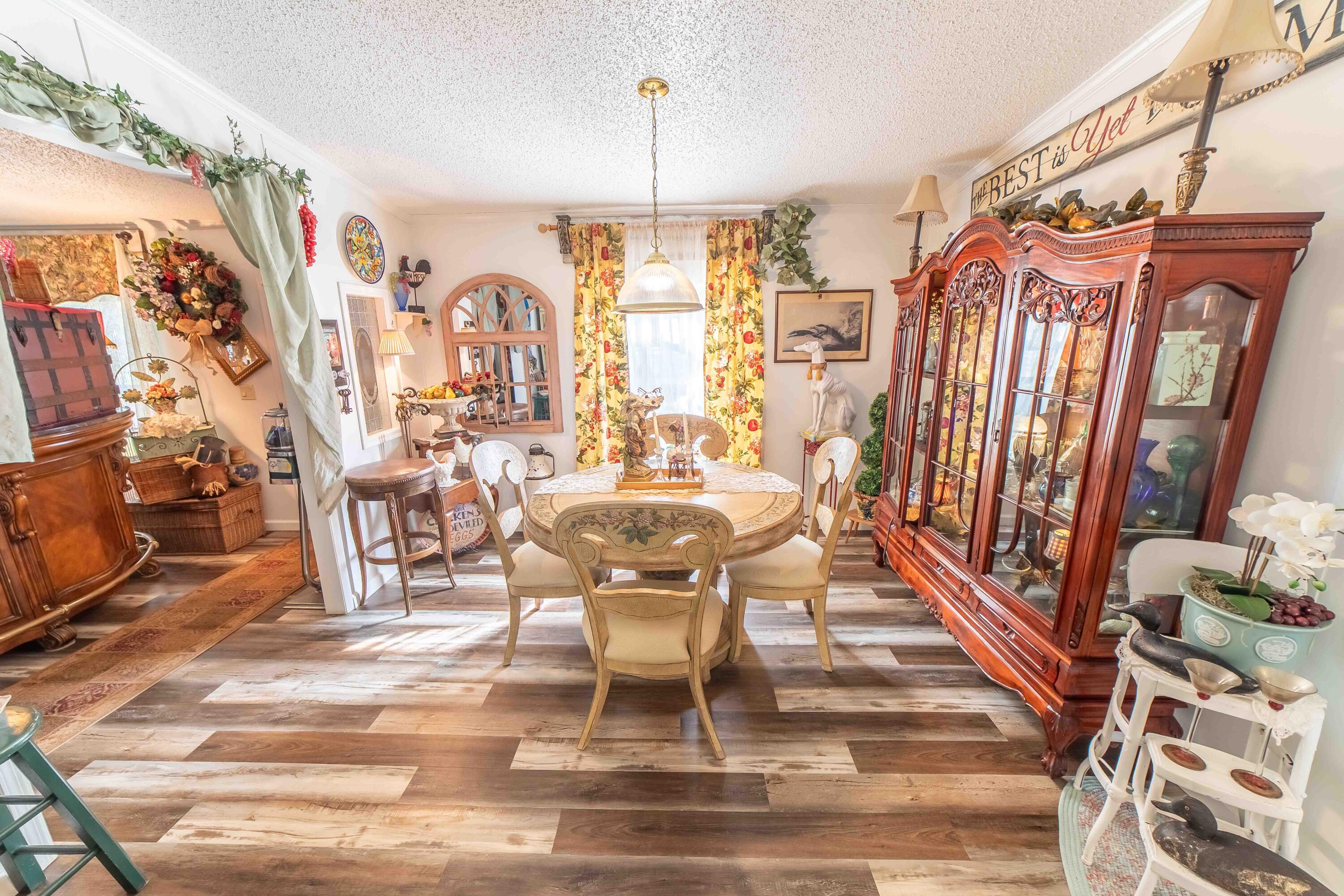 12302 Highway 441 Okeechobee, FL 34974 - Photo 16 of 63 a dining room with furniture a chandelier and wooden floor