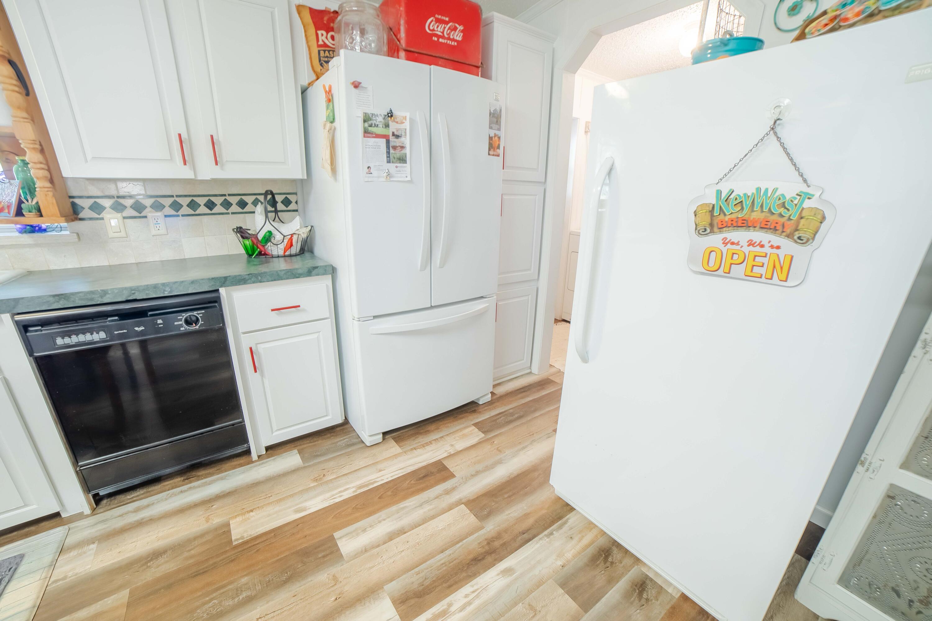 12302 Highway 441 Okeechobee, FL 34974 - Photo 21 of 63 a white refrigerator freezer sitting inside of a kitchen