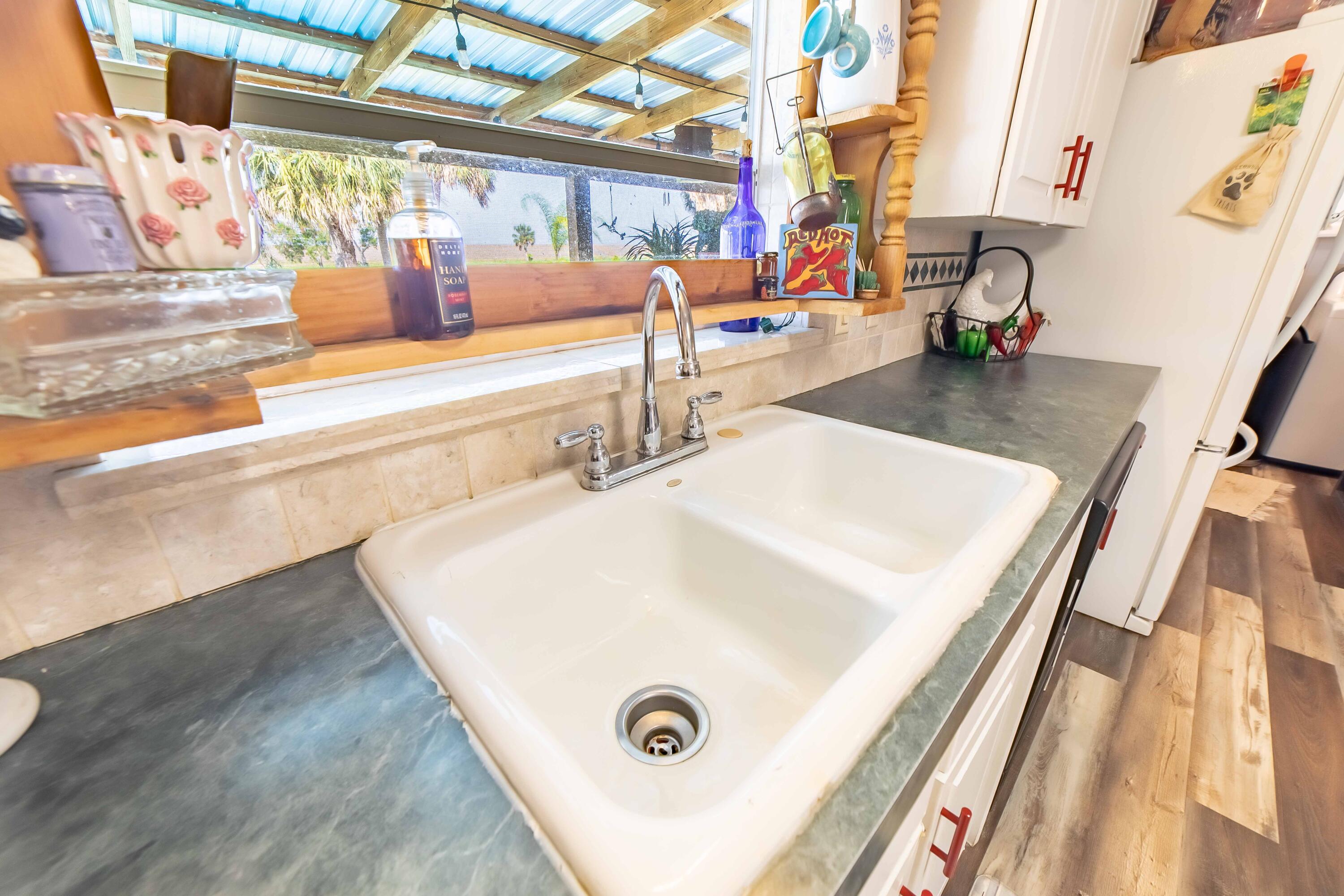 12302 Highway 441 Okeechobee, FL 34974 - Photo 22 of 63 a view of dining room with a sink and wooden floor
