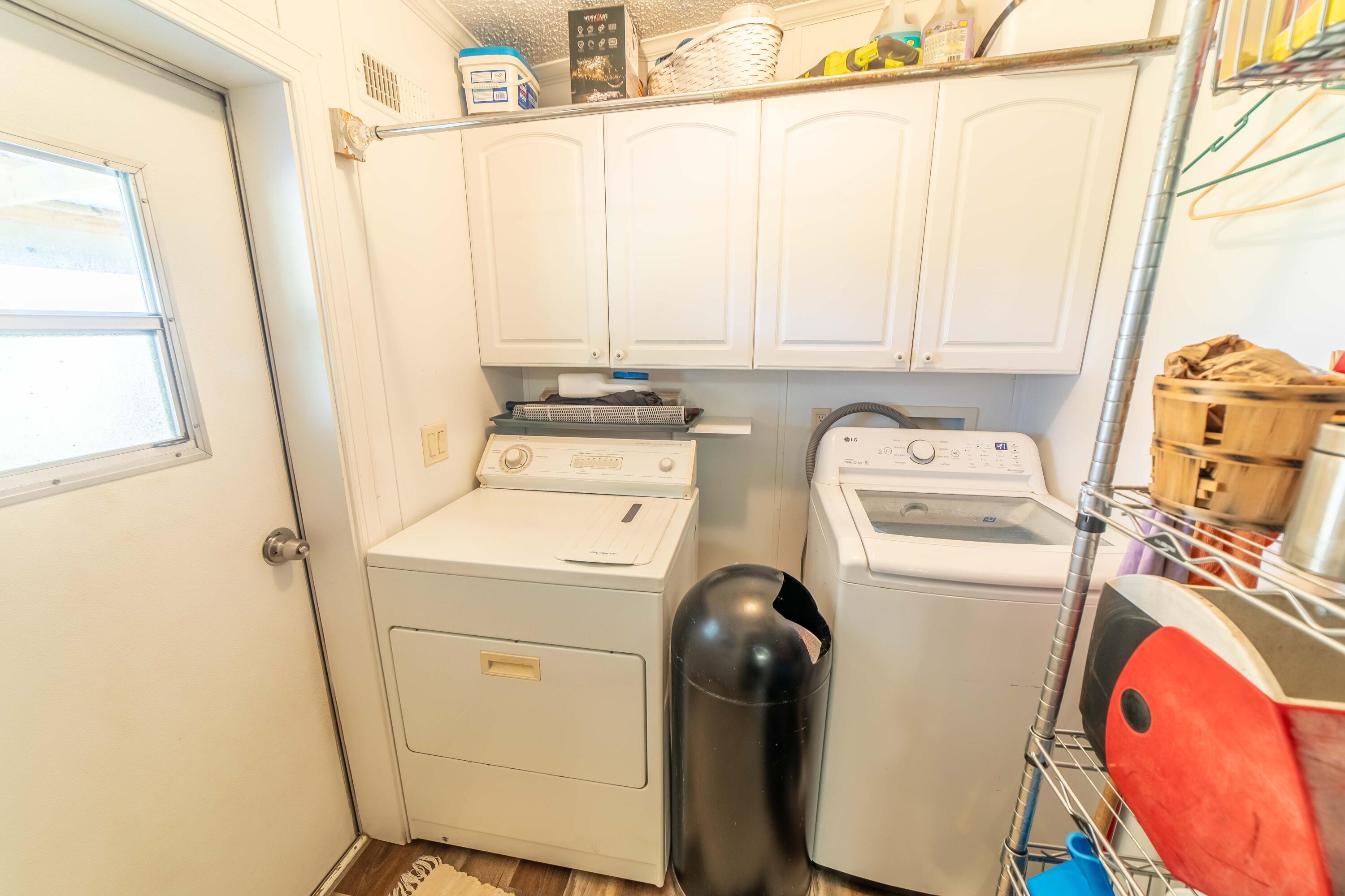12302 Highway 441 Okeechobee, FL 34974 - Photo 24 of 63 a utility room with dryer and washer