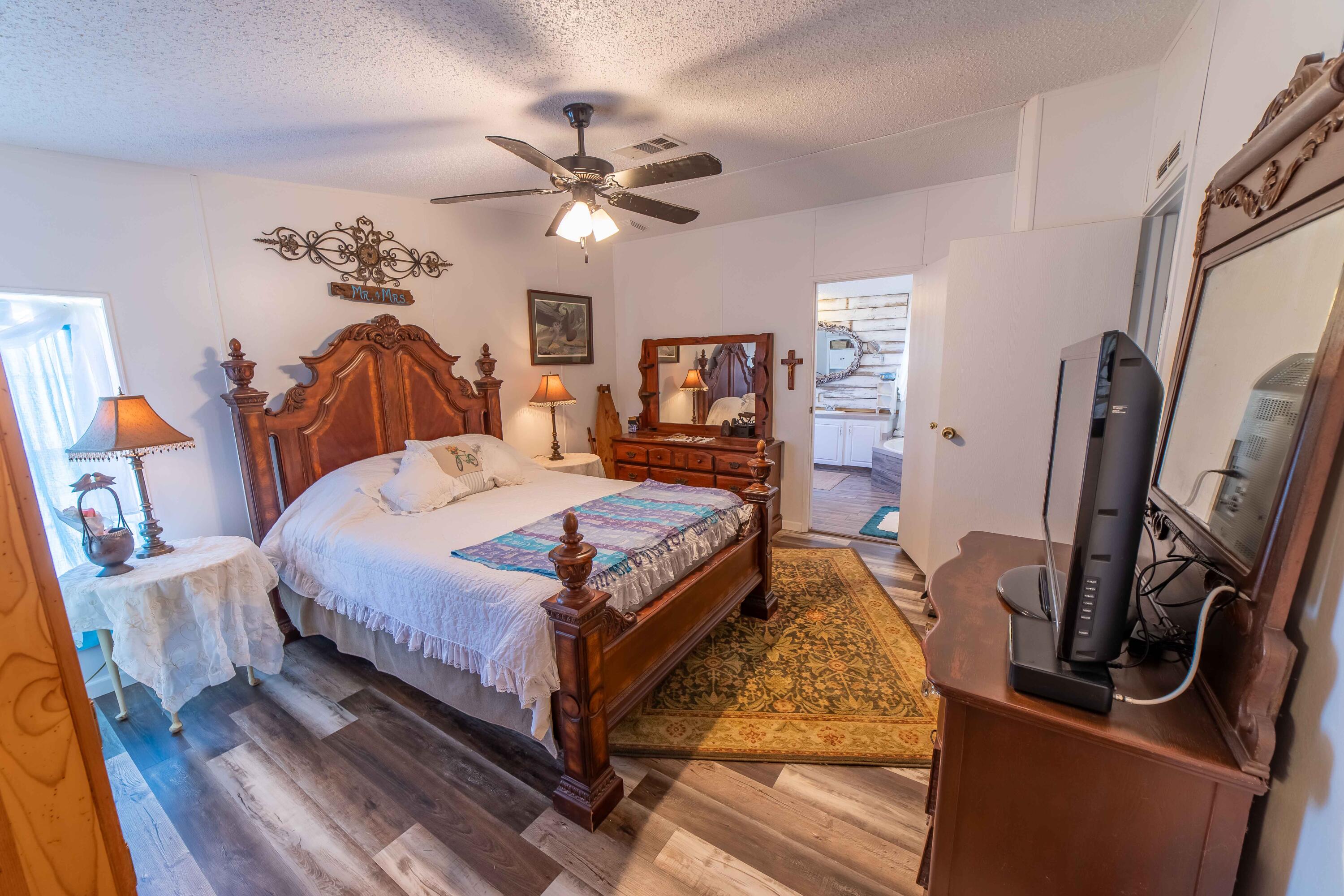 12302 Highway 441 Okeechobee, FL 34974 - Photo 26 of 63 a bed room with a bed and a chandelier