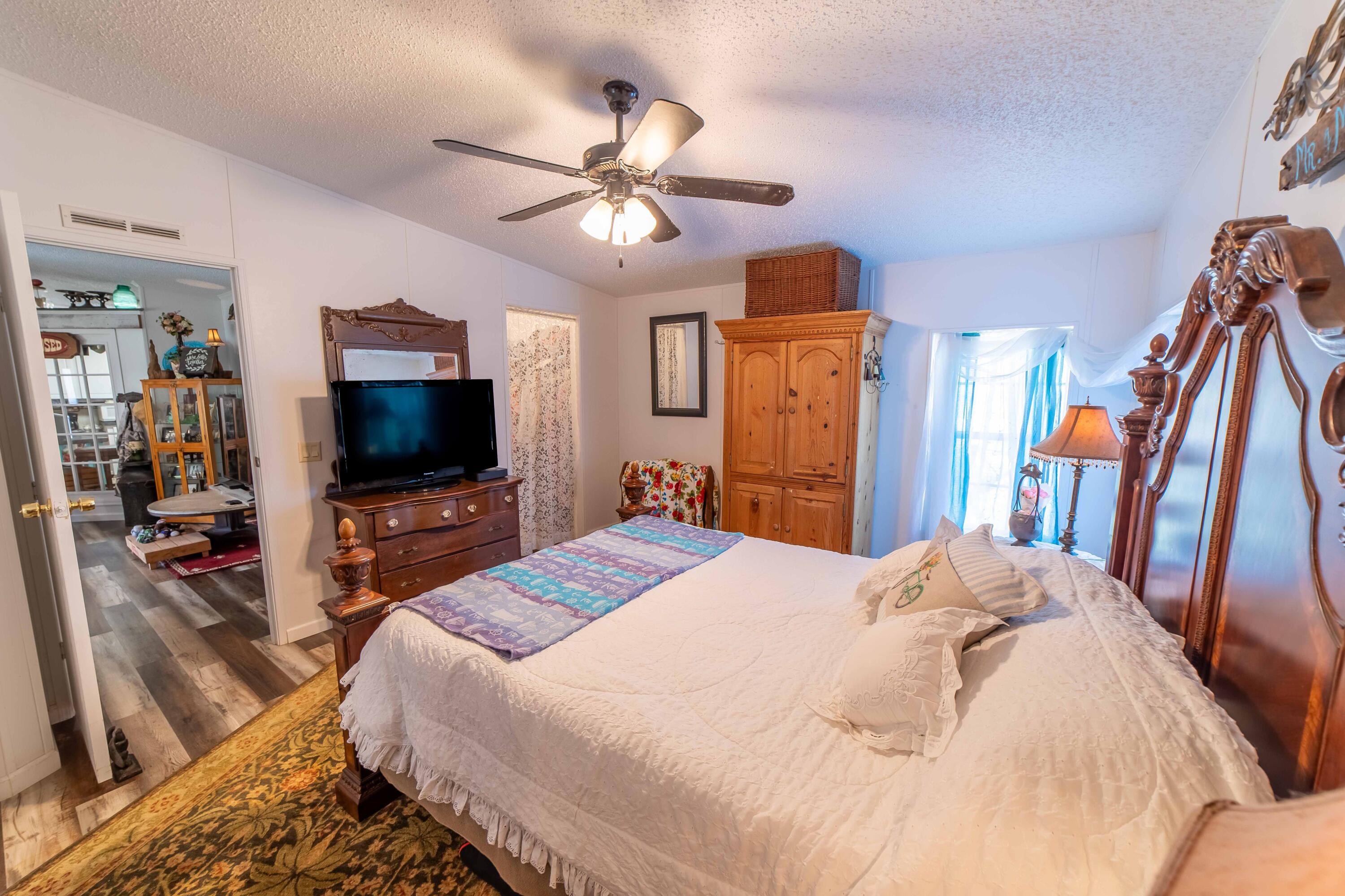 12302 Highway 441 Okeechobee, FL 34974 - Photo 27 of 63 a bedroom with a bed and a flat screen tv